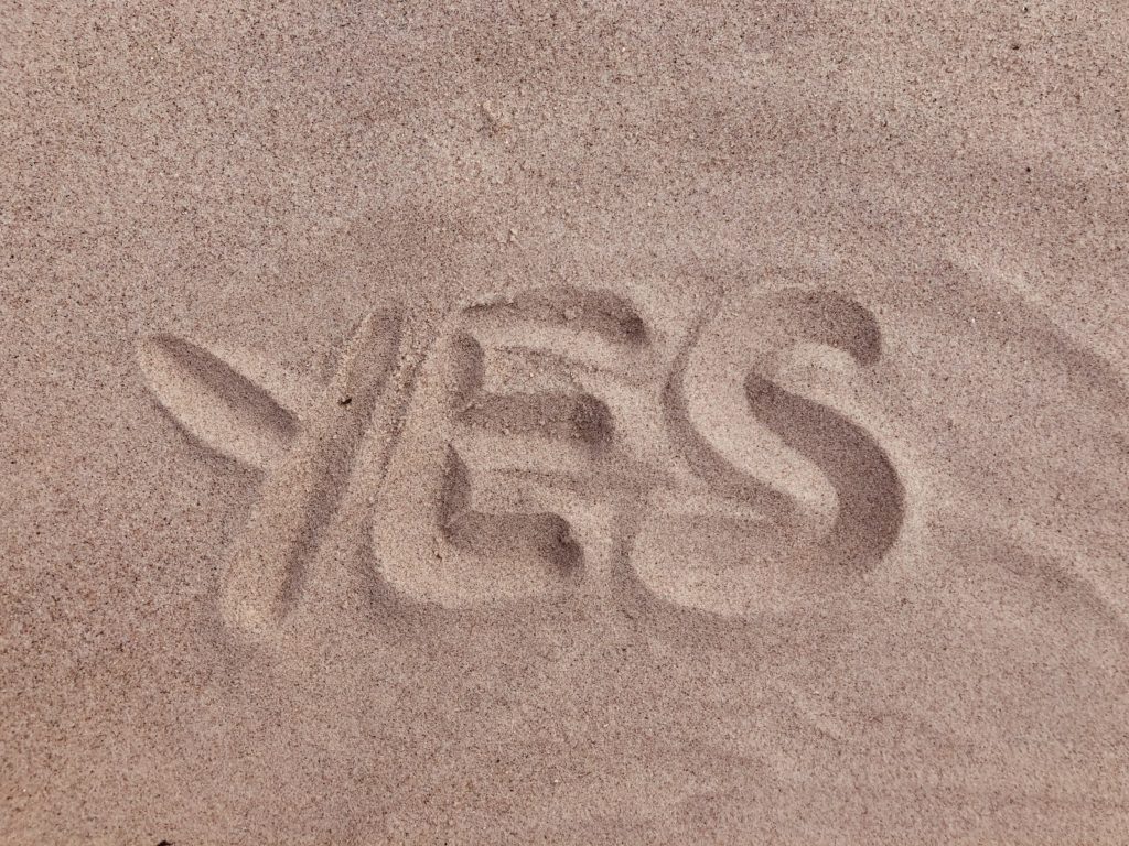 yes text on brown sand